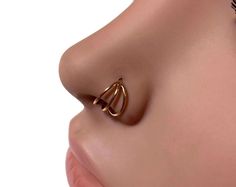 I made this lovely septum ring from solid 14 karat rose gold. It's made to look like a triple hoop, sleek and simple with a high polish. Twist open and close to keep the circle shape, the ends are smooth for easy insertion. Can be worn in a variety of piercings. I can make the ring in various thicknesses and diameters which you can choose at check out. Sizes thickness measure as follows: 18 gauge = 1.02mm 20 gauge = .812mm 22 gauge = .643mm Check out my other nose rings here: https://www.etsy.co Minimalist Hypoallergenic Rose Gold Septum Ring, Hypoallergenic Rose Gold Hoop Septum Ring, Rose Gold 14k Hoop Septum Ring, 14k Rose Gold Nose Rings As Gift, Minimalist Rose Gold Septum Ring As Gift, Internally Threaded Rose Gold Hoop Nose Ring, Rose Gold Hoop Nose Rings As Gift, 14k Rose Gold Nose Rings, Hypoallergenic Rose Gold Septum Ring Gift