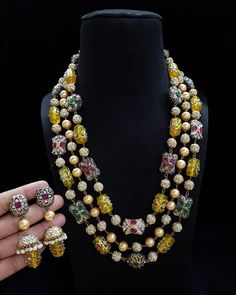 Most eligible gift for someone you love. Inspired by the Nizam of Hyderabad this set has Fine quality Emerald Green, ruby red onyx and Kundan semiprecious beads long necklace with earrings Necklace Length: 19 inches Highest quality and craftsmanship You can ask questions on Email ID: vijaygarg579vg@gmail.com Temple Jewelry Chandbali Pearl Necklace For Party, Multicolor Meenakari Pearl Necklace Gift, Festive Multicolor Pearl Necklace, Bollywood Style Festive Gemstone Jewelry Sets, Heavy Kundan Temple Necklace For Party, Festive Temple Jewelry Style Pearl Necklace With Round Beads, Heavy Beaded Temple Jewelry Necklaces For Festive Occasions, Fusion Style Kundan Necklace As Gift, Party Kundan Necklace With Cutdana And Round Beads