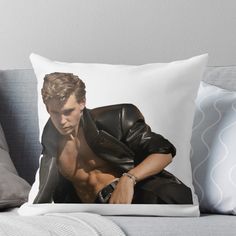 a man in black jacket sitting on a couch with his shirt open throw pillow cover