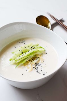 a bowl of soup with celery and black pepper