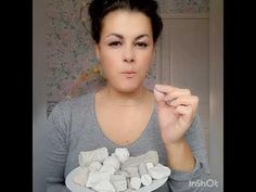 a woman holding a plate with marshmallows on it and pointing to the camera