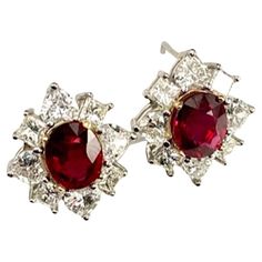 These earrings showcase a gorgeous pair of rubies that match perfectly in color, size and shape. The rubies are 2.13Ct and 2.27Ct and they are surrounded by 8 Natural White Heart Shape Diamonds of 2.08Ct Total Weight and 8 Natural White Princess Cut Diamonds of 1.20Ct Total Weight. The rubies are a stunning deep red, and they are bright, vibrant, and amazingly clean and clear. They sit perfectly on the ear and can be worn for any or no occasion. Elegant Red Oval Diamond Earrings, Luxury Oval Ruby Jewelry, Luxury Lab-created Ruby Earrings For Anniversary, Luxury Oval Ruby Earrings, Luxury White Ruby Earrings, White Princess, Heart Shaped Diamond, Ruby Earrings, White Heart