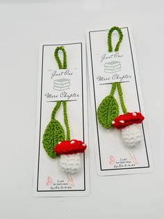 two crocheted bookmarks with red and white mushrooms on them