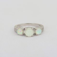 Vintage Sterling Silver White Opal & White Topaz Three stone Ring...Marked 925...Total of weights 3.1grams... Size 6...Measure of stone center 5.9MM...It's in very good condition. Diamond White Multi-stone Round Ring, White Birthstone Ring With Round Stone, White Round Diamond Birthstone Ring, White Round Diamond Ring Birthstone, White Birthstone Ring, Sterling Silver Opal Ring With Accent Stones, Sterling Silver Opal Ring With Accent Stones For Anniversary, Classic Opal Jewelry For Anniversary, Silver Opal Ring With Accent Stones, Round Cut