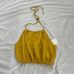 Zara Viscose Blend Halter Top Size Medium Condition: Nwt Color: Mustard Yellow Details : - Self Tie - Open Back - 58% Viscose , 42% Polyamide Solid Summer Crop Halter Top, Summer Halter Neck Top In Solid Color, Solid Cotton Halter Top For Summer, Yellow Halter Neck Top For Vacation, Trendy Yellow Solid Color Top, Yellow Halter Top For Spring Vacation, Gold Sleeveless Crop Top For Summer, Gold Crop Top For Summer, Green Crop Top For Summer