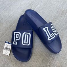 Nwt Polo Ralph Lauren Cayson Slide Sandals. Navy Blue With White Spell Out Polo Logo. Size 11d. Very Sharp. Rare Find. Never Been Worn. The Padded Eva Construction Provides Extra Support And Comfort. Perfect For The Gym, Beach, Shower, Or Traveling. Features: Open Toe Slip-On Styling Padded Footbed Eva Midsole Ralph Lauren's Signature Polo Spell Out On Top Polo Slides Men, Polo Slides, Aqua Logo, Polo Ralph Lauren Shoes, Ralph Lauren Jacket, Polo Logo, Camo Men, Polo Sport Ralph Lauren, Ralph Lauren Shoes