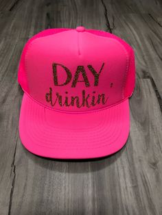 "Day Drinkin' Trucker Hat 100% Polyester Foam Front, Soft Mesh Back, Structured, Mid-profile, 3.5\" Crown, Five-panel with braid, Plastic Tab Closure. One Size. Please let us know if the note section what color print you would like on your hat. We have almost every color glitter and regular vinyl as well as gold and silver foil. The color you select in the drop down menu is the color of the hat. If you do not leave a note for the print color choice, we will select the default color for you. All Pink Baseball Cap Mini Hats For Party, Pink Mini Baseball Cap For Parties, Novelty Snapback Party Hats, Fun Snapback Baseball Cap For Parties, Novelty Trucker Hat For Party, Fun Party Snapback Baseball Cap, Adjustable Flat Brim Trucker Hat For Party, Party Snapback Hat With Curved Brim, Party Trucker Hat Baseball Cap Adjustable