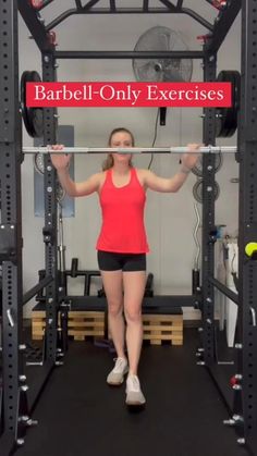 a woman standing in front of a barbell exercise machine