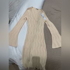 Still Has Tags. Is More Of An Off White/Cream Hue As Seen In Photos. Never Worn - Didn’t Fit Me. Beautiful Dress And Amazing Quality Though! Chic Cream Sweater Dress, Chic Cream Sweater Dress For Spring, Cream V-neck Sweater Dress For Spring, Chic Long Sleeve Sweater Dress For Beach, White V-neck Pointelle Knit Dress, Chic Cream Knit Dresses, White Pointelle Knit Sweater Dress, Beige V-neck Sweater Dress For Summer, Cream Long Sweater Dress For Spring