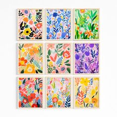 six floral paintings are arranged in squares on a white surface, each with different colors