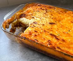 a casserole dish with meat and cheese in it on a counter top, ready to be eaten