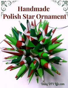 an ornament made out of green, red and white paper straws with the words handmade polish star ornament