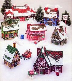 there are many small houses made out of knitted wool and decorated with christmas decorations