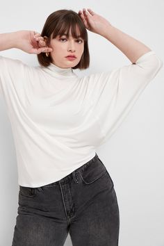 "Stunning day-to-night style. A tale of two halves, our Hamilton Top is all about eye-catching and versatile asymmetry. Crafted from soft, high-stretch and sustainable European jersey with a relaxed fit, she's designed with a dropped-shoulder short sleeve on one side and a mid-length batwing sleeve that drapes down your arm on the other. An asymmetric bottom hem creates a slant on the hip. The look is pure geometric chic. MODEL INFO: Maritza, in black, is 5'9\" (177 cm) tall, wearing size XS. Na Batwing Shirt, White Short Sleeve Blouse, Batwing Top, Night Style, Sweatshirt Fabric, Mock Neck Top, Fashion Night, Oversized Top, Sports Top