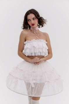 This darling, miniature Marie Antoinette structured hoop skirt evokes the elegance of the 18th-century French court, updated for the modern era. Crafted from gossamer gauze and accented with dainty pink bows, this is an utterly beguiling accompaniment to any dress or skirt. Styled here with our Dauphine Top and Knickers in Ivory. Mini Hoop skirt with tiny pink bow details throughout Structured cage to add volume to skirts and dresses Non-stretch waistband with invisible zipper closure To ensure Silk Dressing Gown, Corset Skirt, Hoop Skirt, Puff Dress, Pink Bows, Fashion Aesthetics, Knitted Coat, Modern Dress, Marie Antoinette