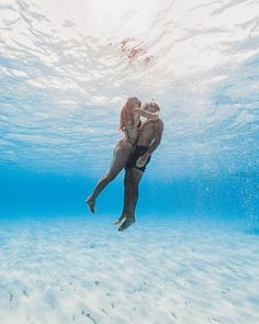 a man is swimming in the ocean with his back to the camera