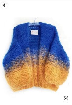 a blue and yellow sweater hanging on a hook