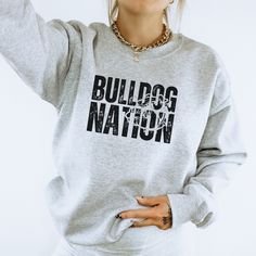 Everyone will be asking where you got this one! Perfect for any tiger fan! Show your school spirit with this awesome sweatshirt! 50/50 Cotton & Polyester Blend. Gildan Brand Fit: All shirts are unisex fit, true to size, loose fit. Recommend going up 1-2 sizes for an oversized look. Please check the size chart. If you have any questions, please contact us. Please check your address to make sure it is your current address. Care Instructions:  For the best and lasting results, wash in cold water inside out. No bleach. Dry on low heat or hang dry. Do not iron over design.  Returns: Because this item is made to order, all sales are final. No returns are accepted.  Please let us know if you have a problem with your order and we will try to correct the issue.  Shipping: Orders usually ship within Bulldog Spirit Shirt Ideas, Bulldog Shirts School Spirit, School Spirit Week, School Apparel, Bulldog Sweatshirt, Team Sweatshirts