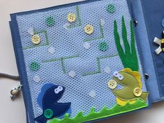 a close up of a piece of cloth with buttons on it and fish in the water