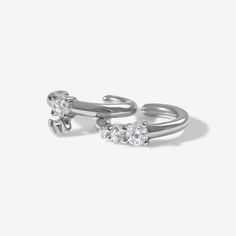 This crystal ear cuff set is about to become this seasons staple. Juana's dainty cubic zirconia crystal setting, wraps one ear cuff and swings from the other, adding a little luxe to your favorite look without all the OTT-ness. Pair it alongside a pretty crystal hoop earring for ultimate accessorizing. Created with a sterling silver base and utilizing luxury Rhodium plating, this Adorn Luxe earring is everything you love about our standard collection, but with a ‘demi-fine’ jewelry finish. Silver Cubic Zirconia Ear Cuff For Anniversary, Anniversary Silver Cubic Zirconia Ear Cuff, Anniversary Cubic Zirconia Single Ear Cuff, Silver Ear Cuff With Diamond Accents As Gift, Adjustable Silver Cubic Zirconia Cartilage Earrings, Silver Ear Cuff With Diamond Accents, Adjustable Silver Cartilage Earrings With Cubic Zirconia, Silver Diamond Accents Ear Cuff As Gift, Silver Cubic Zirconia Ear Cuff With Diamond Accents