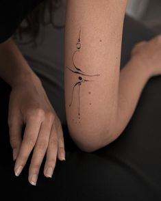 a woman's arm with a small tattoo on the left side of her leg