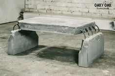 a concrete bench sitting in front of a brick wall with metal brackets attached to it