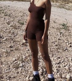 a woman standing on a skateboard in the desert