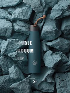 a water bottle sitting on top of rocks with the words bubble acum up above it