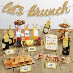 a table topped with lots of food and drinks next to a sign that says eat brunch