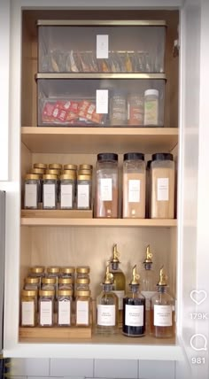 an open pantry filled with lots of different types of food and condiments on wooden shelves