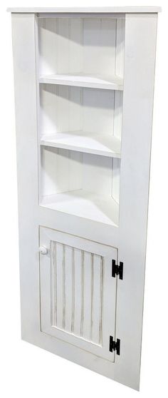 a white bookcase with black handles and shutters