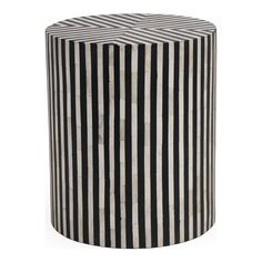 a black and white striped stool sitting on top of a table