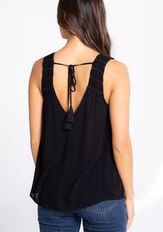 We love this dreamy tank top for its flattering relaxed fit and light-as-air crepe fabrication. The braided trim and tassel ties add a bohemian feel. Perfect for day or night, this effortless top pairs well with denim. Braided trim Relaxed fit Sleeveless Round hemline V-neckline in front and back Tassel tie closure at the back Sheer Elevated basics Model is 5'9, wearing a size S in Black and Blue Fog. Model is 5'10, wearing a size S in Yellow.Style: I-13697W-RQW Flowy Sleeveless Rayon Top, Summer Rayon Tank Top For Vacation, Bohemian Sleeveless Top With Tie Straps, Casual Sleeveless Blouse With Tie Back, Casual V-neck Tops With Tassel Ties, Chic Rayon Tank Top For Beach, Chic Vacation Tank Top With Smocked Back, Chic Tank Top With Smocked Back For Vacation, Casual Summer Tops With Back Tassel Tie-up