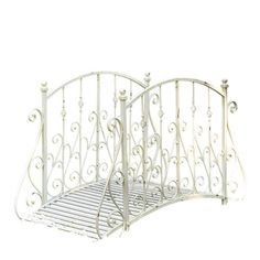 a white wrought iron bed frame against a white background