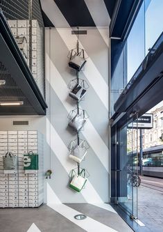 the interior of an office building with several shelves and bins on the wall above them