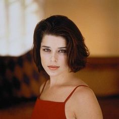 a woman in a red dress posing for a photo