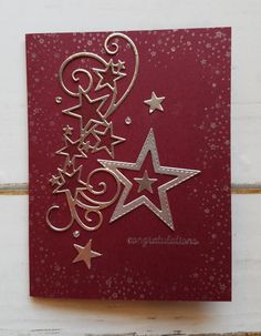 a red card with stars and swirls on it