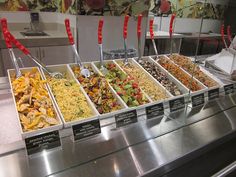 an assortment of food is on display in a buffet