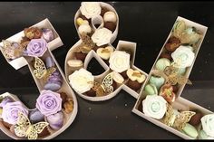 the letters are made out of cupcakes and decorated with flowers