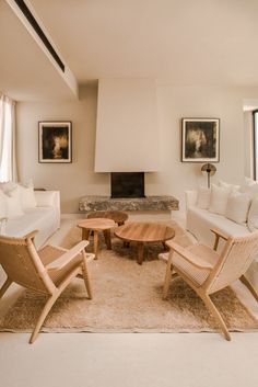 a living room filled with furniture and a fire place in the middle of the room