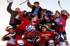 a group of young people standing next to each other on top of snow covered ground