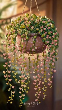 a hanging planter with pink and green flowers in it's center is filled with tiny hearts