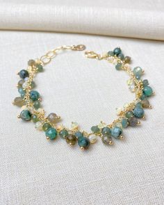 Stunning beaded charm bracelet featuring earthy colors of green emerald, golden labradorite, forest green kyanite, and ethereal opal in gold fill. Adjustable fit. Green Kyanite, Beaded Charm Bracelet, Green Beaded Bracelets, Cluster Bracelets, Beaded Jewlery, Emerald Bead, Handmade Jewelry Diy, Green Emerald, Earthy Colors