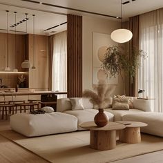 a living room filled with lots of furniture next to a dining table and window covered in curtains