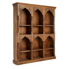 an old wooden bookcase with many shelves