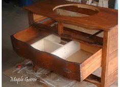 an unfinished wooden desk with drawers on the bottom and one open drawer in the middle