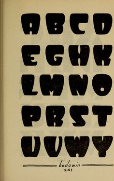 an old book with some type of alphabet on it's cover and the letters are black