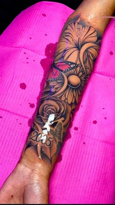 a woman's arm with a flower tattoo on the left side of her arm