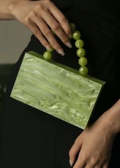 Introducing the Bead Handle Acrylic Mini Box Bag; an exclusive and elegant addition to any wardrobe. The box bag is adorned with a luxurious bead handle, crafted from beautiful acrylic, and showcases a stunning green hue. An elegant and tasteful must-have. Green Beaded Rectangular Bag, Green Square Beaded Bag, Elegant Rectangular Box Bag For Summer, Chic Box Bag With Pearl Handle, Elegant Square Box Bag For Summer, Summer Formal Green Bags, Trendy Green Beaded Bag, Formal Handheld Green Box Bag, Elegant Summer Box Bag Perfect For Gifts