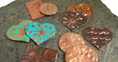 several different shapes and sizes of heart shaped buttons on top of a granite slab with white background